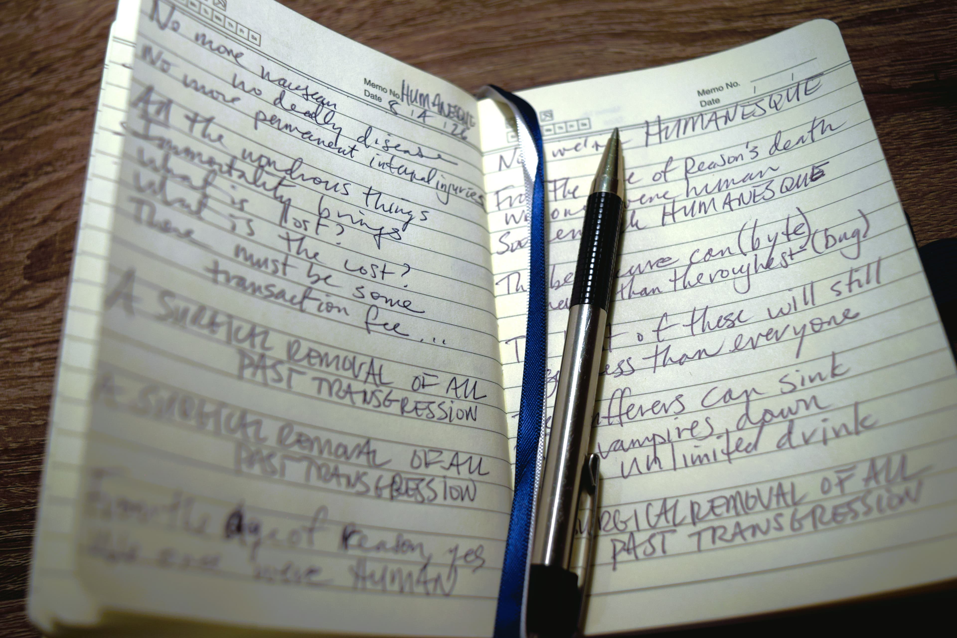 A handwritten notebook page of song lyric drafts